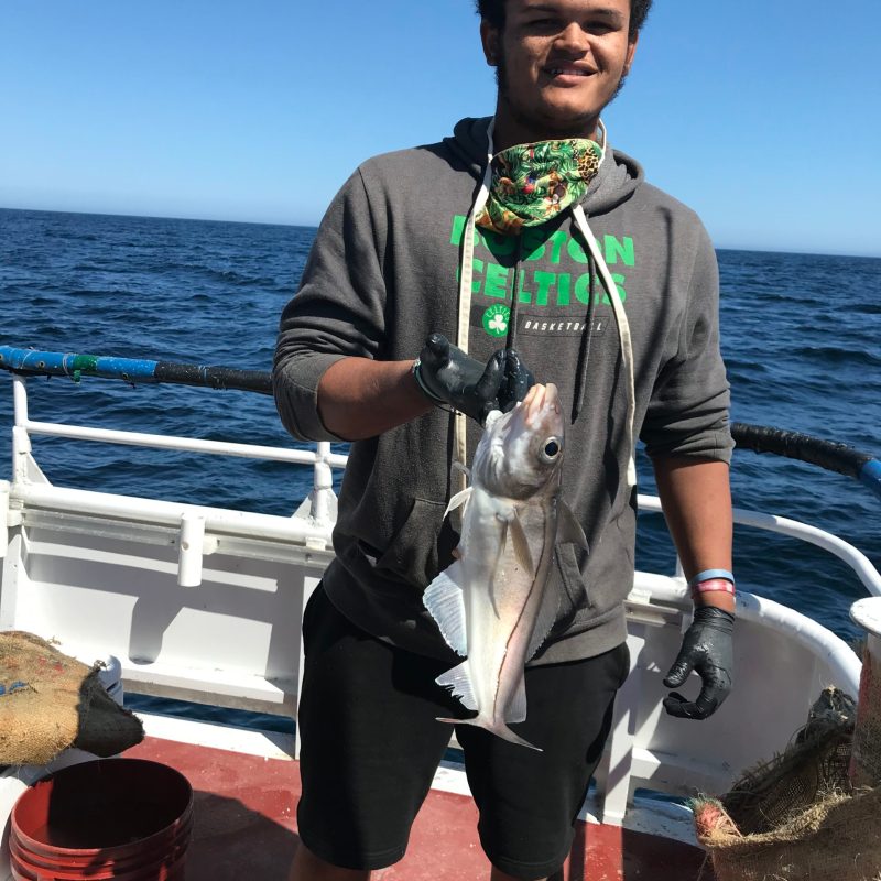 a man holding a fish in the water