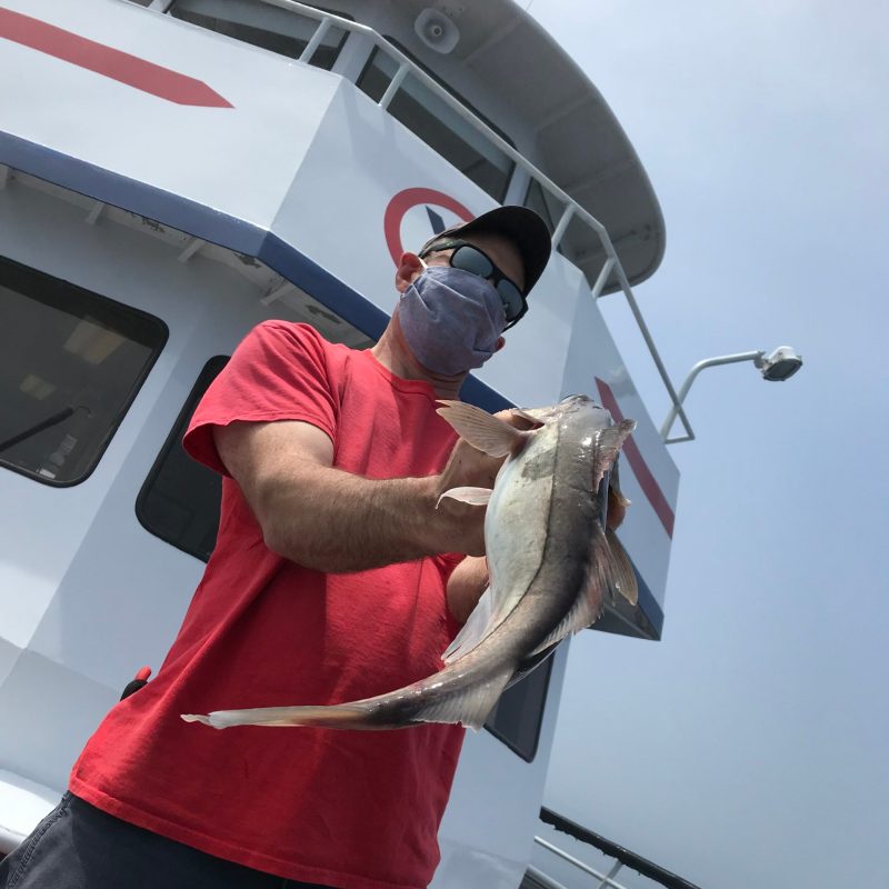 a man holding a fish