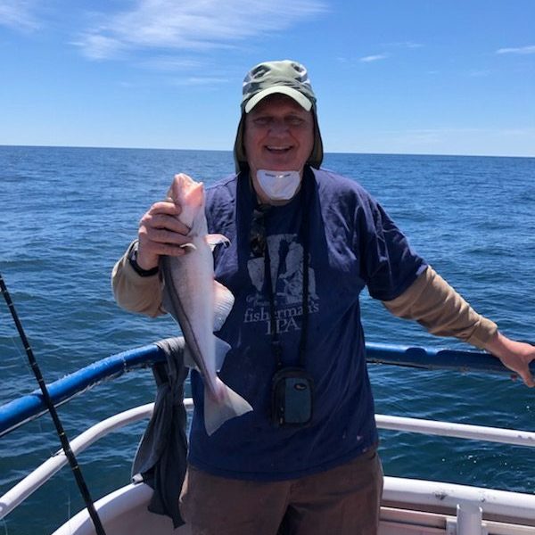 a person standing next to a body of water
