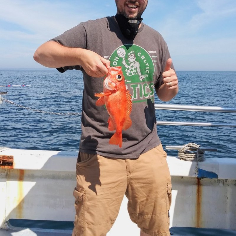 a man standing next to a body of water