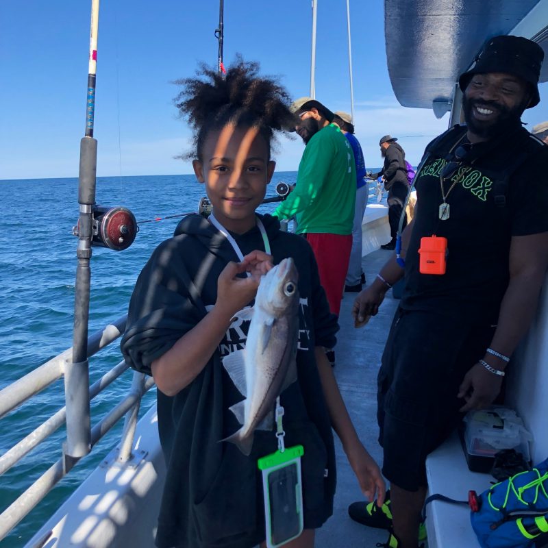 a group of people standing on a boat