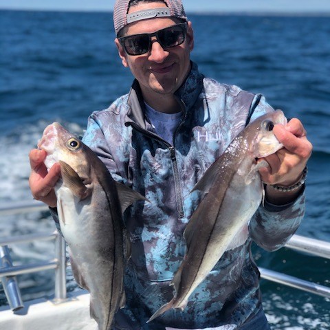 a man holding a fish in the water