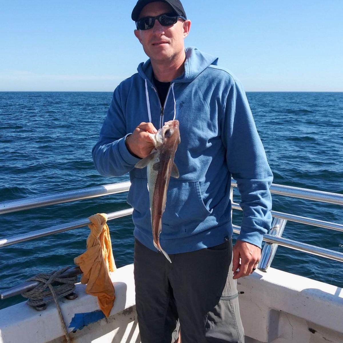 a man standing next to a body of water