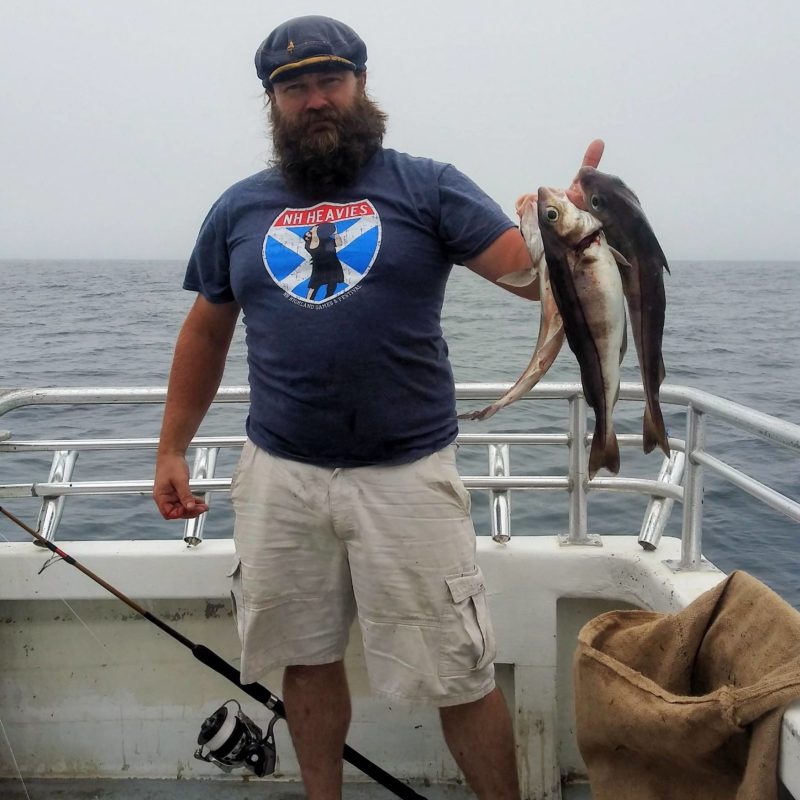 a man sitting on a boat in the water