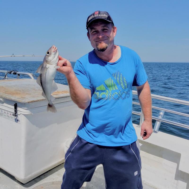 a person holding a fish in the water