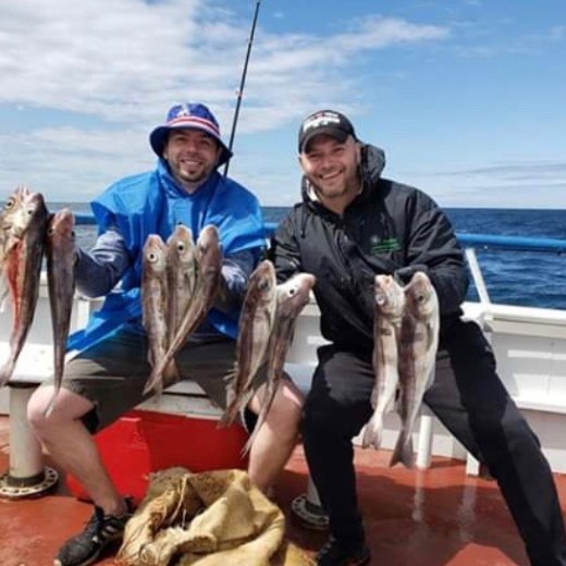 a person holding a fish in the water