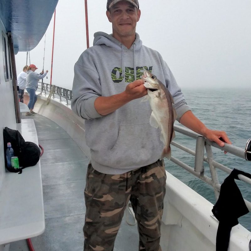 a man holding a fish