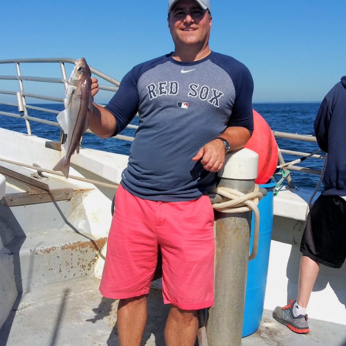 a person holding a fish on a boat