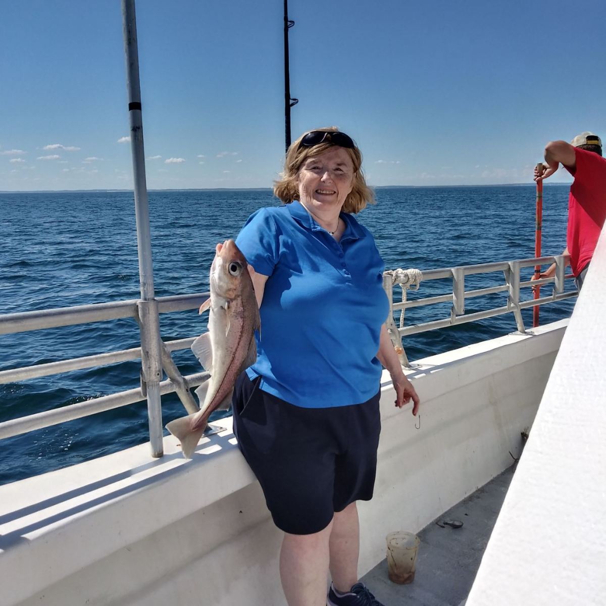 a person standing next to a body of water