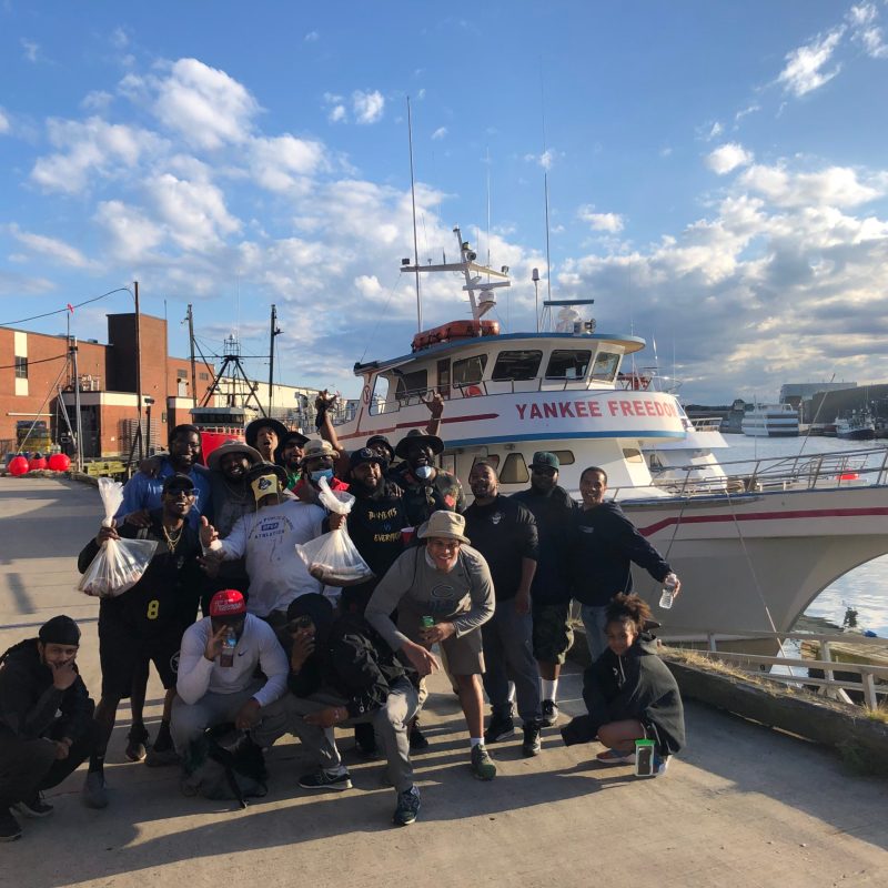 a group of people standing in a parking lot