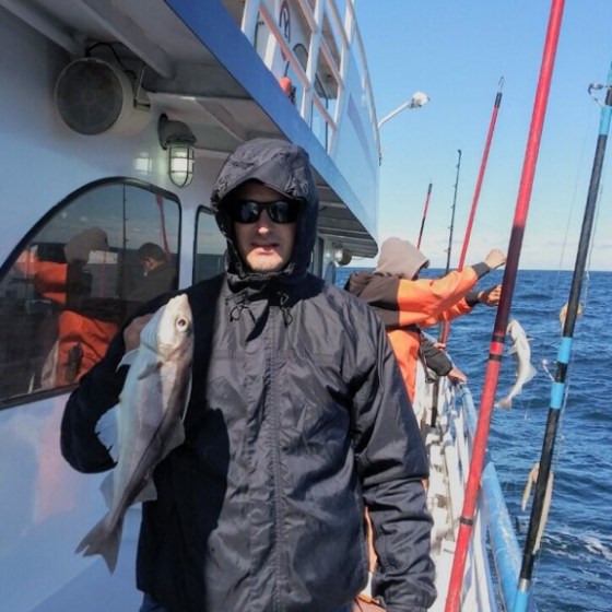 a man standing in front of a boat