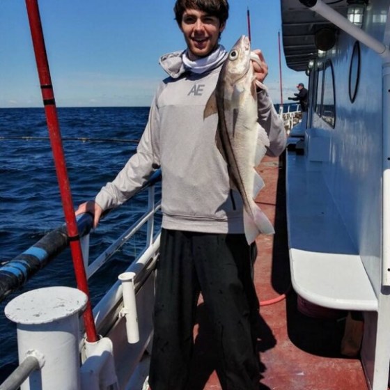 a man standing in front of a body of water