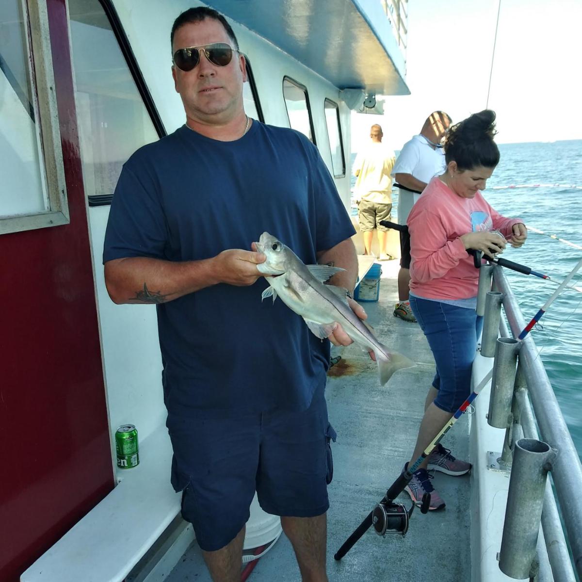 a man standing next to a boat