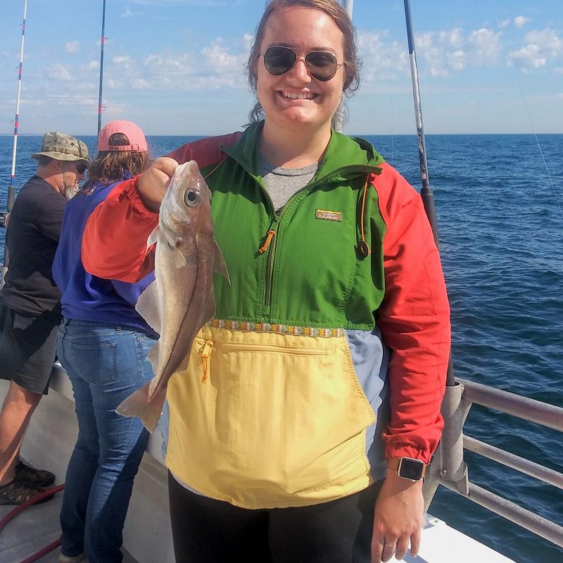 a man and a woman holding a fish