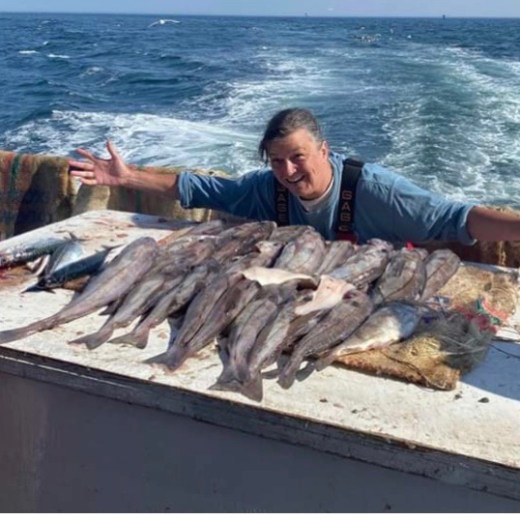 a man holding a fish in the water