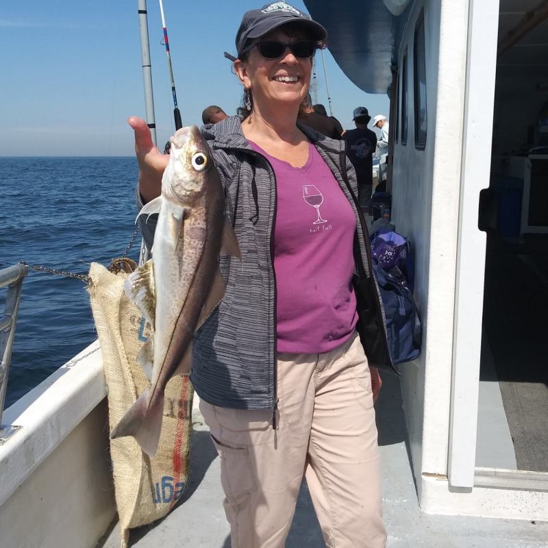 a person holding a fish in the water