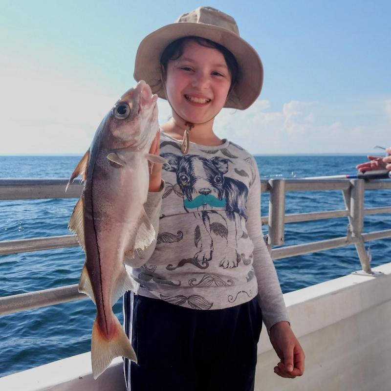 a person holding a fish in the water