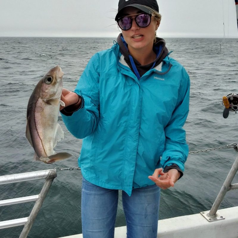 a woman holding a fish in the water