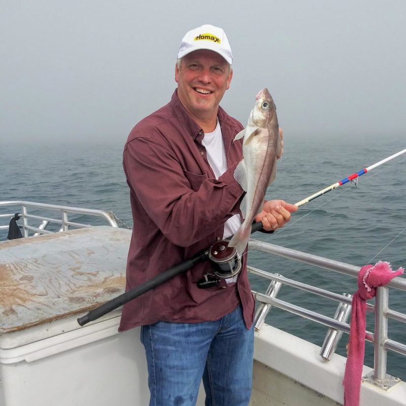 a man and a woman standing on a boat