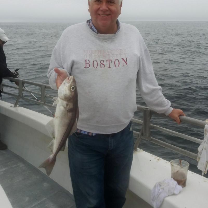 a person holding a fish in the water
