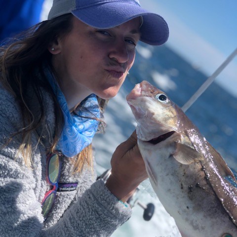 a person holding a fish