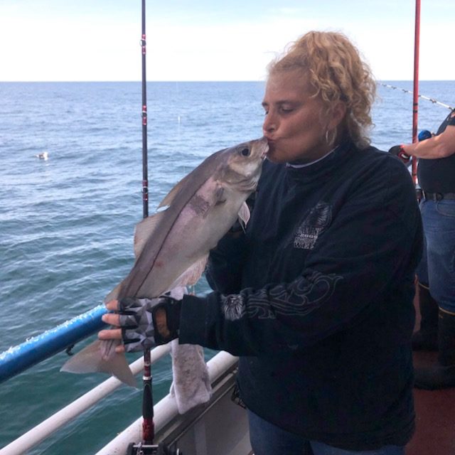 a person standing next to a body of water