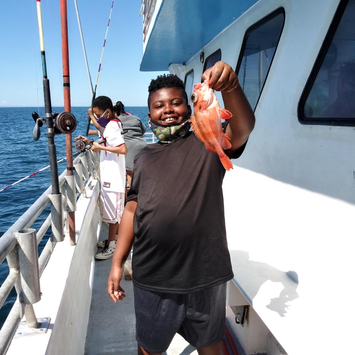 a person standing next to a boat
