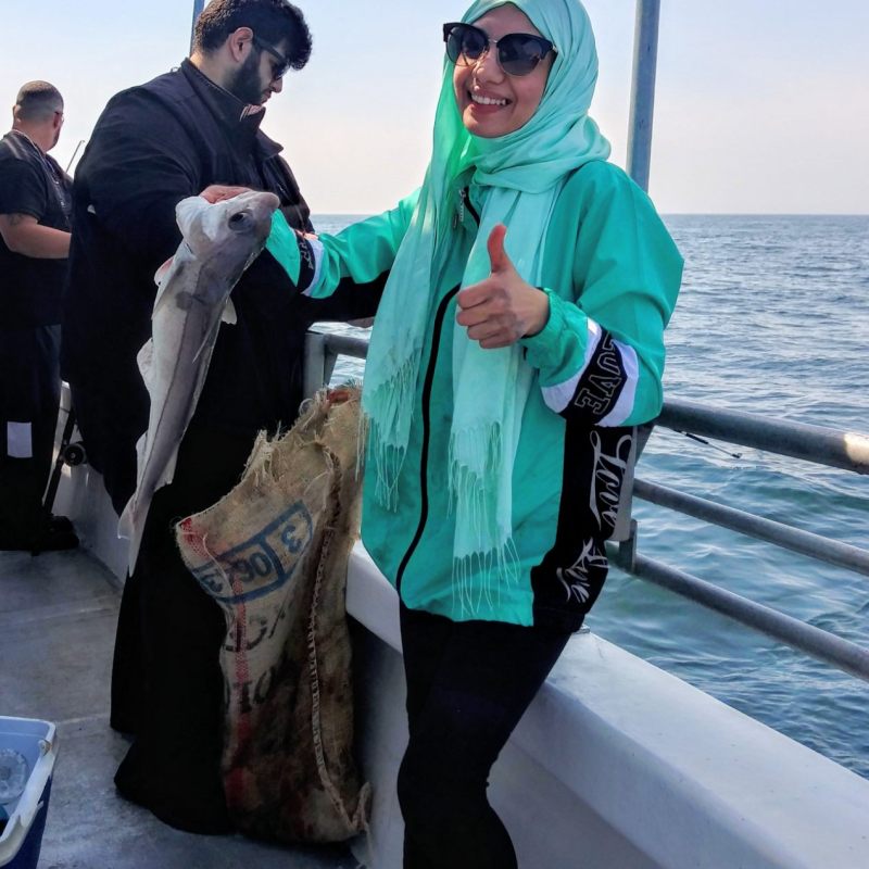 a group of people standing next to a body of water