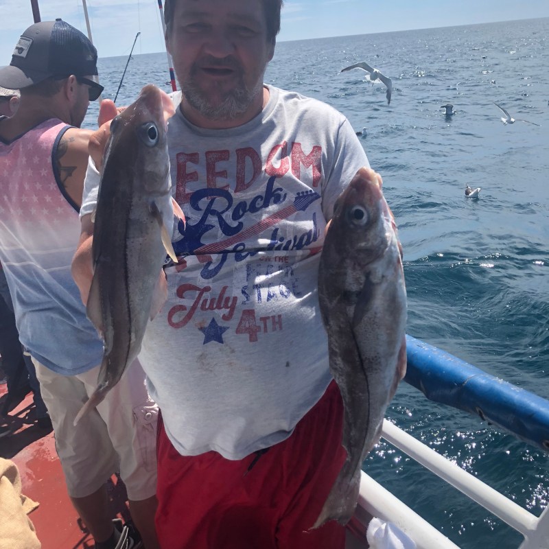 a man holding a fish in the water