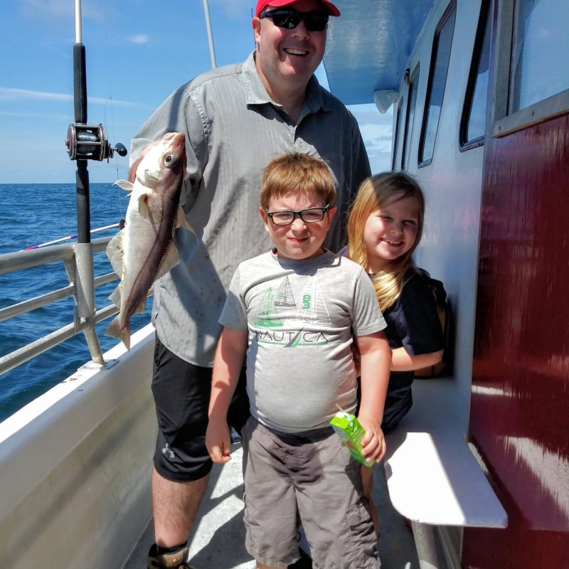 a man standing next to a boat