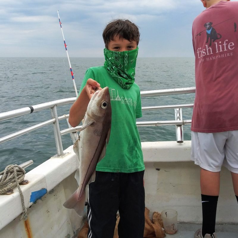 a man holding a fish in the water