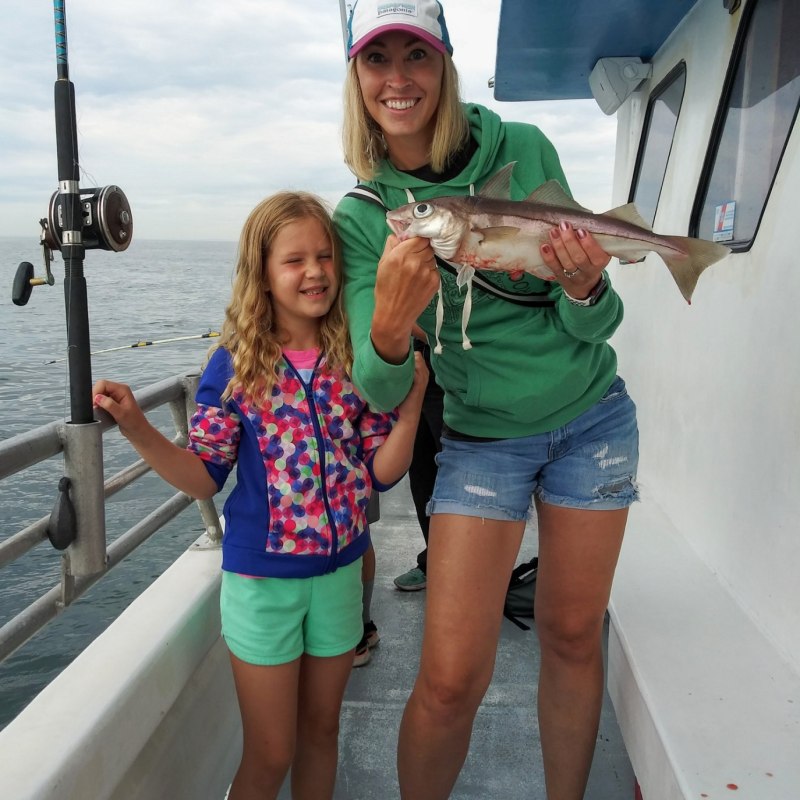 a woman holding a fish