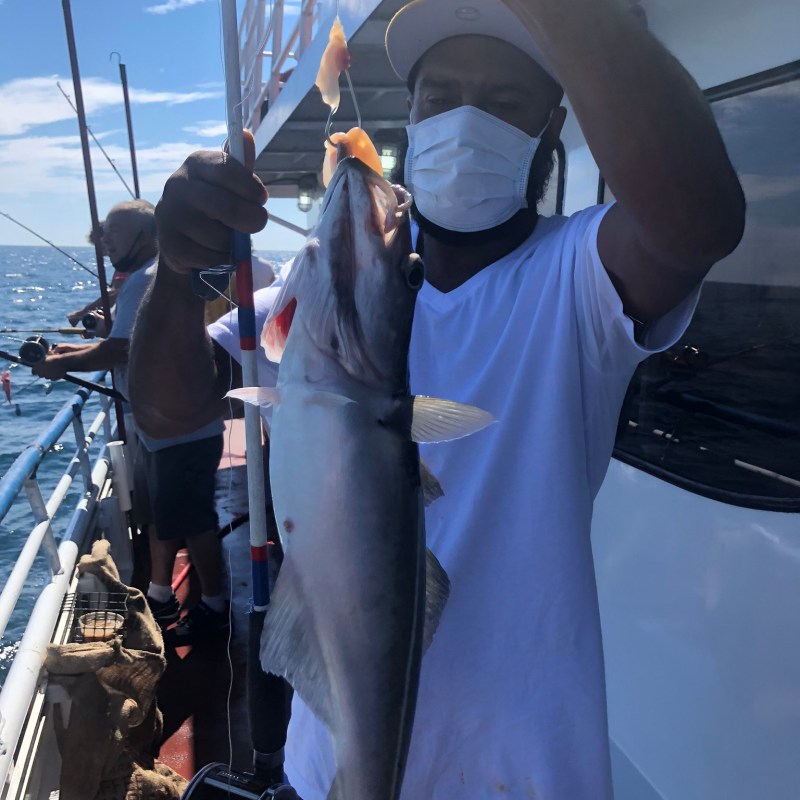 a man standing next to a boat
