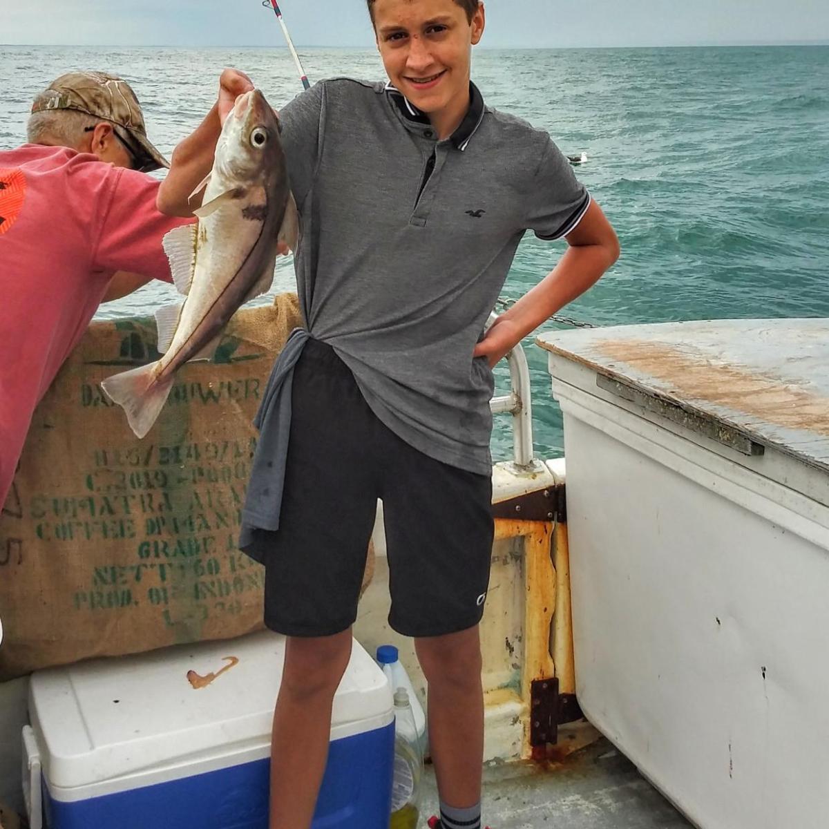 a person holding a kite in a boat on the water