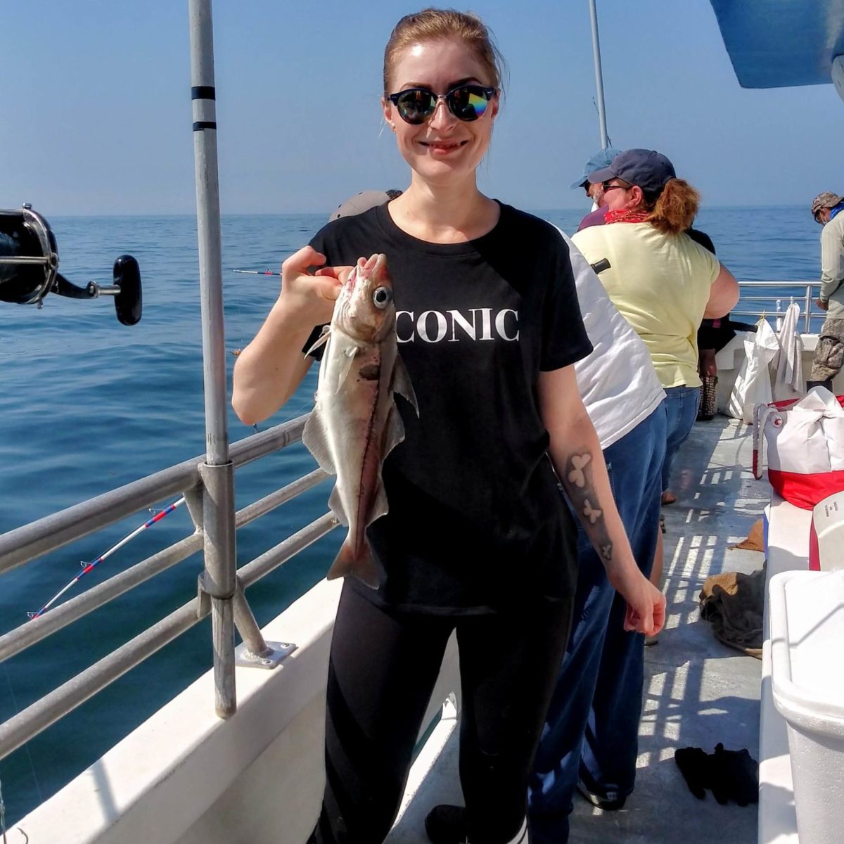 a man and a woman standing on a boat