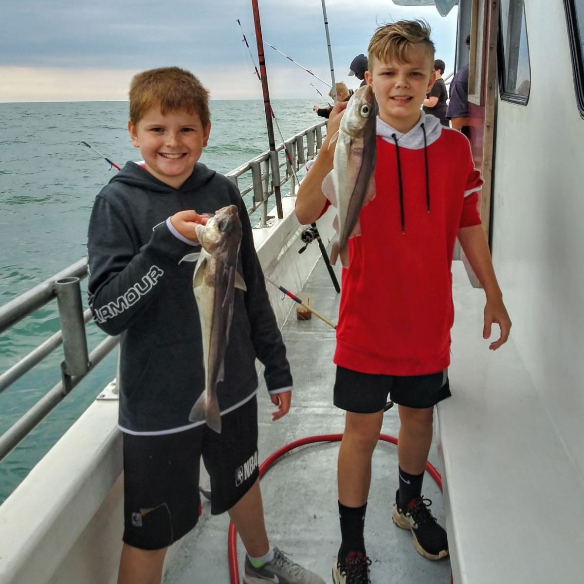 a little boy standing next to a child