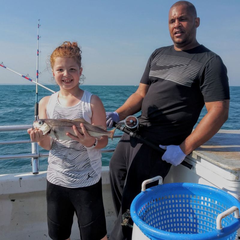 a couple of people that are standing in the water