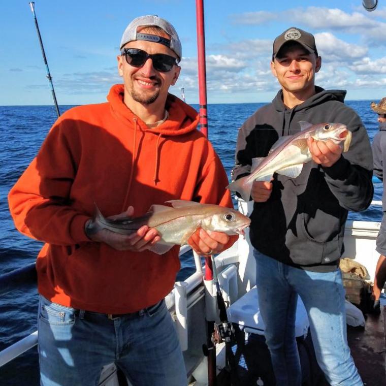 a person holding a fish in the water