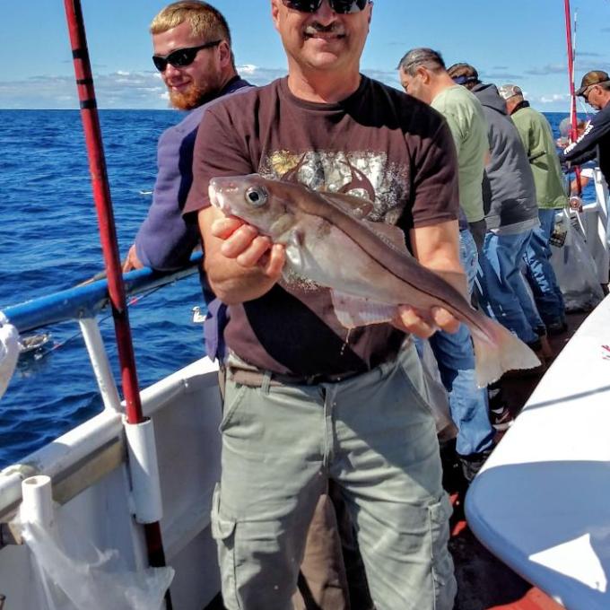 a man holding a fish in the water