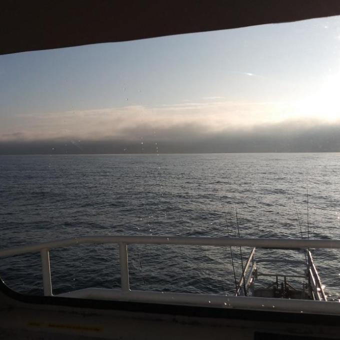 a bench overlooking the ocean at sunset