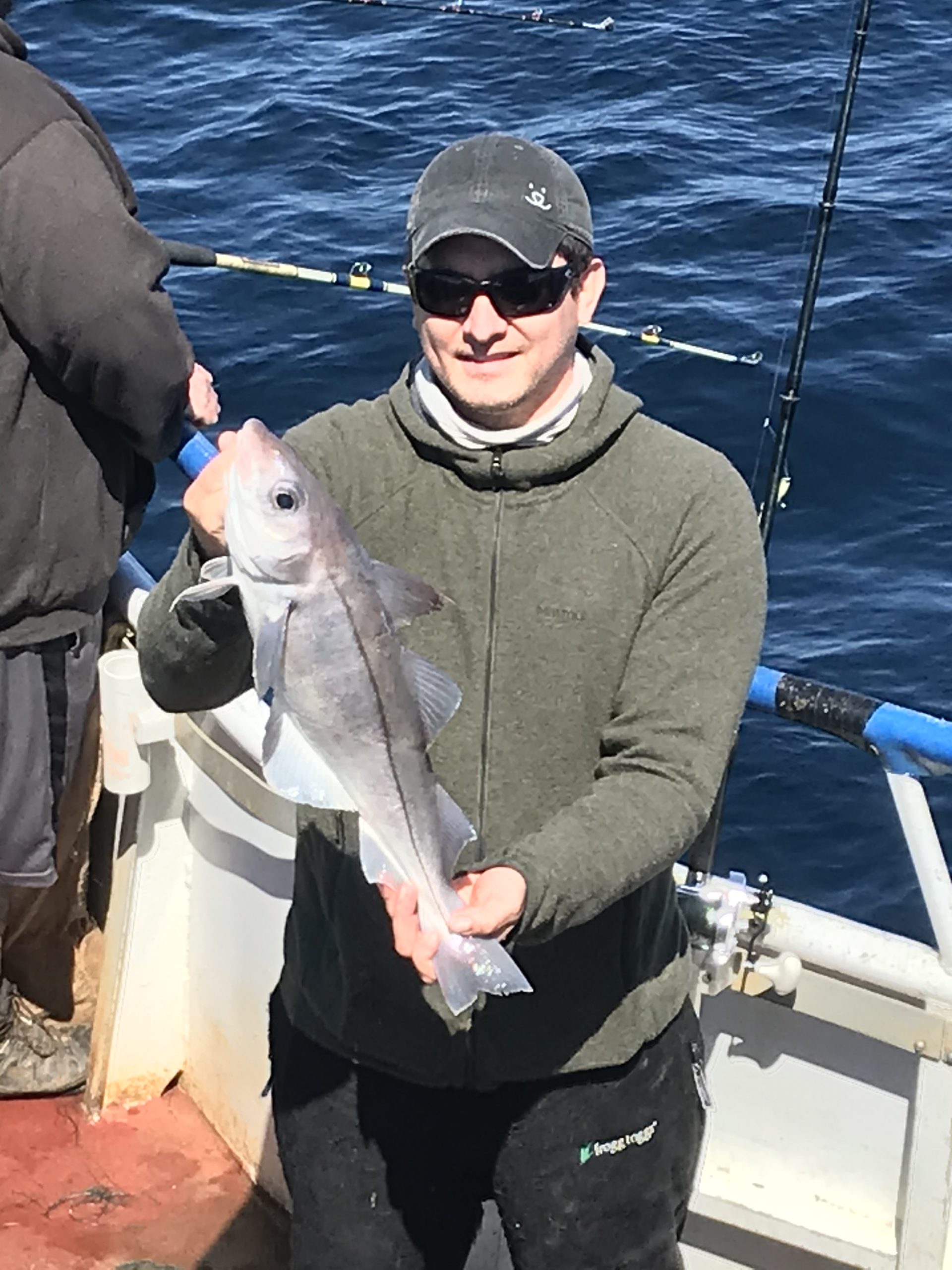 a person holding a fish on a boat