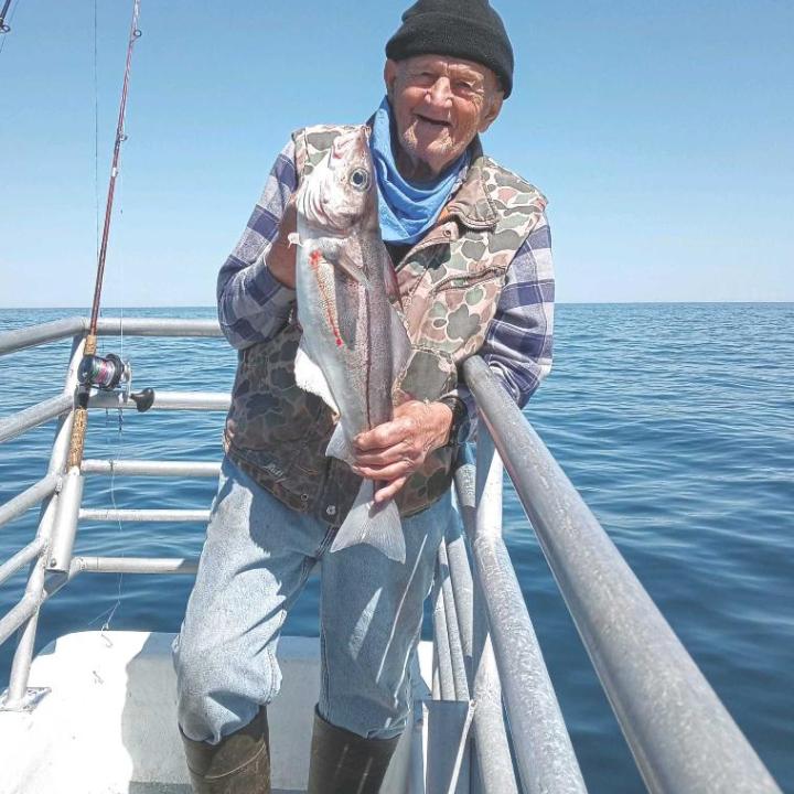 a person holding a fish in the water