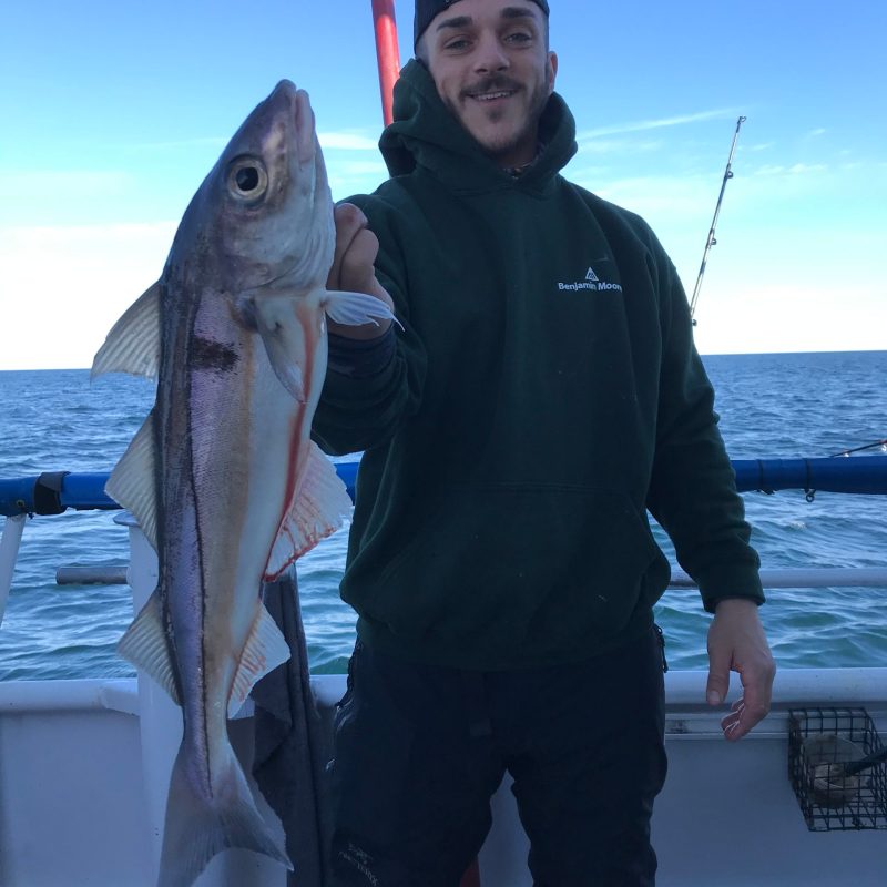 a man holding a fish in the water