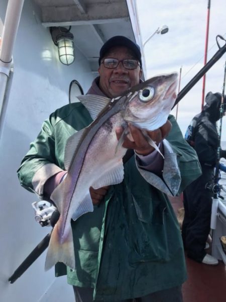 FFAFD2AD-CE25-432D-A186-537E61FB4784 a person holding a fish