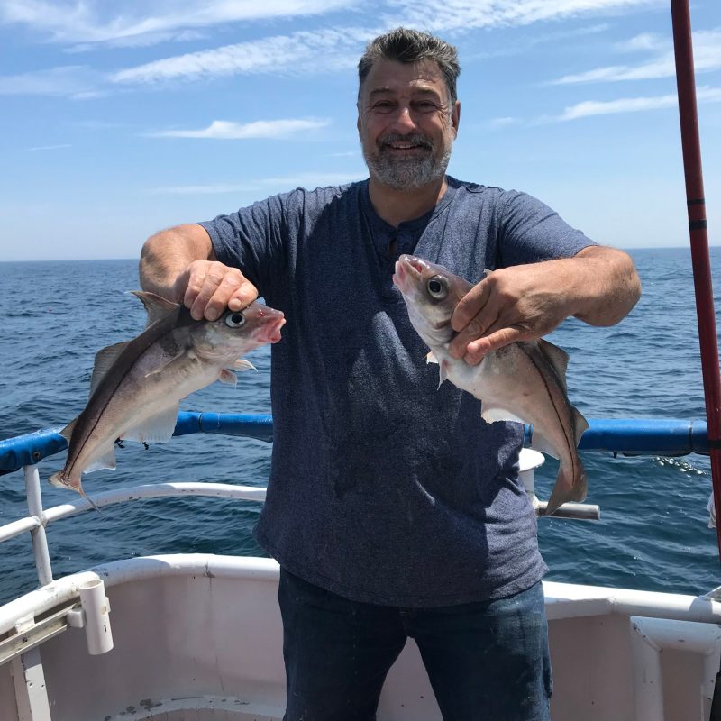 William Keith standing in front of a body of water