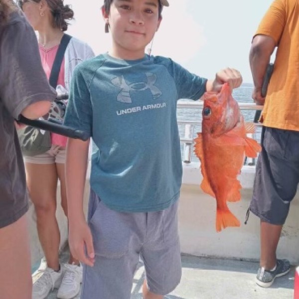 a group of people standing on a sidewalk