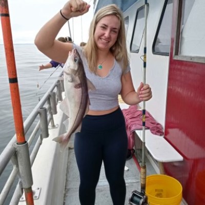 a woman standing next to a boat