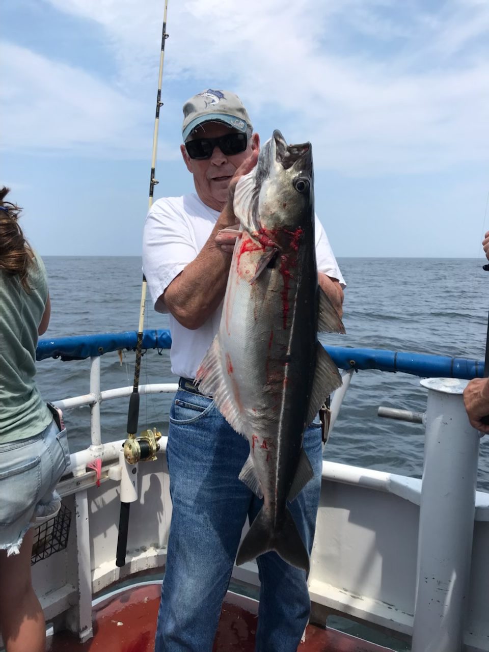 a person holding a fish on a boat in the water