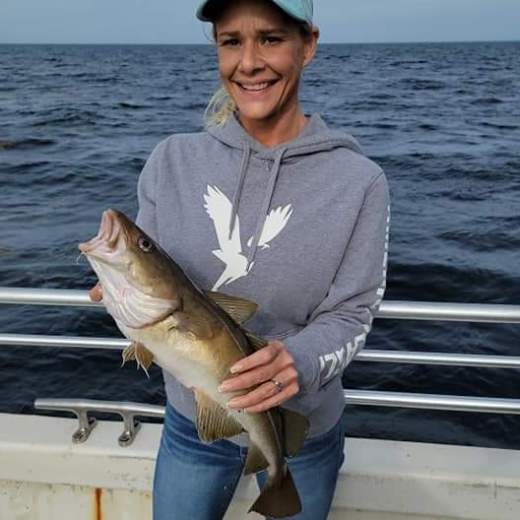 a person holding a fish in the water