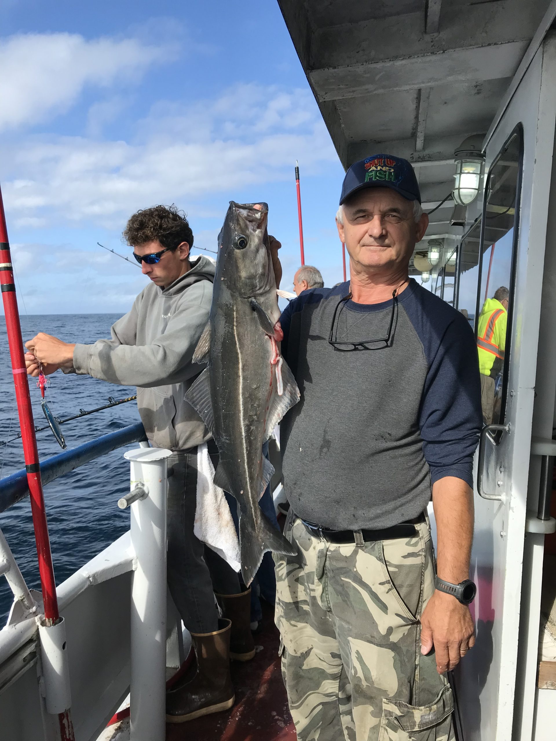 a man standing next to a boat